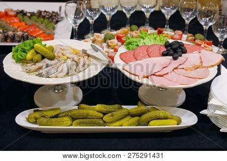 Pieces Of Herring, Pickles And Ham On The Plates, Fourche Table