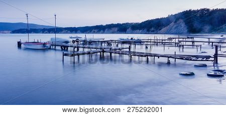 Fishing Boats And The Pier. Long Exposure Seascape During Sunset, Blue Hour In The Harbour Near Byal