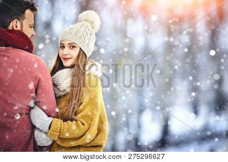 Happy Young Couple In Winter Park Laughing And Having Fun. Family Outdoors. Copycpace.