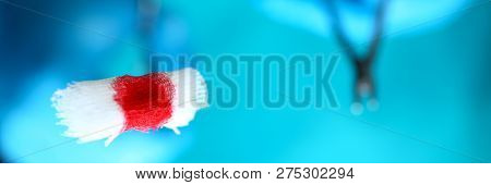 Surgeon In Sterile Uniform Arms Holding And Passing To Colleague Tools With Bio Material Wad Closeup