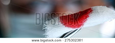 Surgeon In Sterile Uniform Arms Holding And Passing To Colleague Tools With Bio Material Wad Closeup