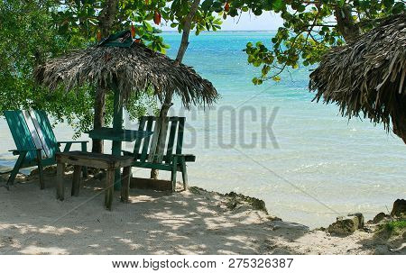 Photo Of  Famous Wild Public Beach With Green Old Beach Chairs  At The Morning ,  Dominican Republic