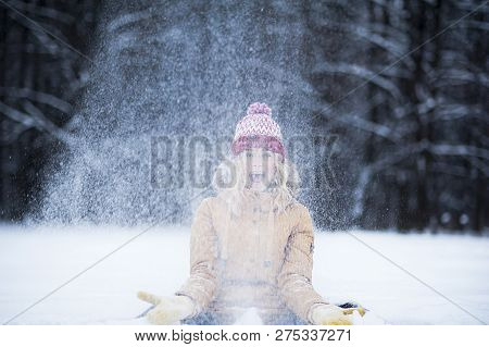 Very Beautiful Bright Young Girl In A Red Hat And Yellow Mittens On The Background Of A Winter Park