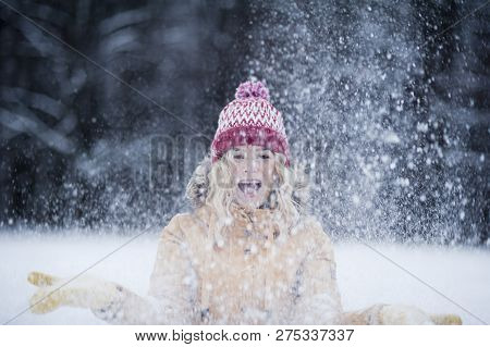 Very Beautiful Bright Young Girl In A Red Hat And Yellow Mittens On The Background Of A Winter Park