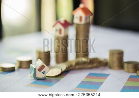 Mini House On Stack Of Coins,money And House,  Mortgage, Savings Money For Buy House And Loan To Bus
