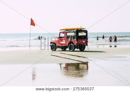 Arambol Goa India November 24, 2018 View Of A Red Lifeguard Jeep Parked  On The Beach Of Arambol In 