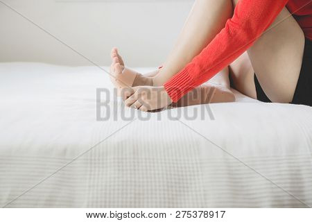 Woman Using Support Silicone For Treatment Plantar Fasciitis On Her Foot In Bedroom