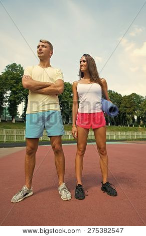 Sport And Fitness Couple. Man And Woman Redy For The Training Standing At Stadium At Sunn Day With E