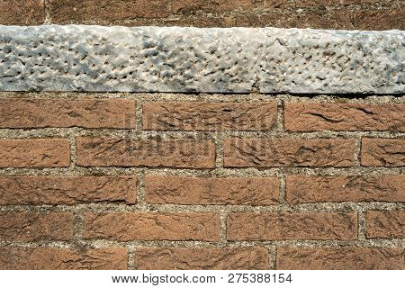 Background With Brown Bricks And A White Marble Slab