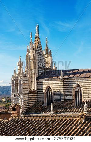 Close-up Of The Siena Cathedral (santa Maria Assunta) 1220-1370 With Blue Sky And Clouds. Tuscany, I