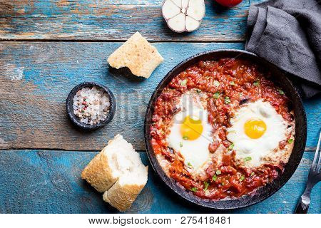 Shakshuka, Fried Eggs In Tomato Sauce In Iron Frying Pan. Typical Israel Food. Top View.