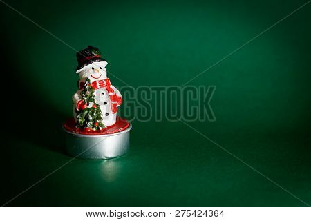Snowman Figurine Isolated On Green Background, Christmas Decoration Concept, Interior Design