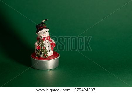Snowman Figurine Isolated On Green Background, Christmas Decoration Concept, Interior Design
