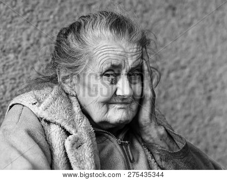 Very Old And Tired Wrinkled Woman Outdoors