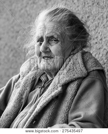 Very Old And Tired Wrinkled Woman Outdoors