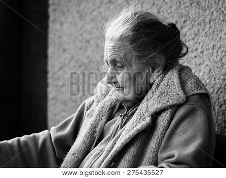 Very Old And Tired Wrinkled Woman Outdoors