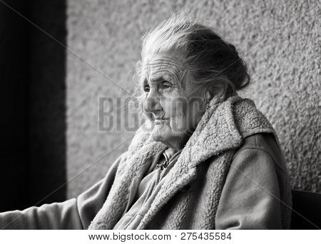 Very Old And Tired Wrinkled Woman Outdoors