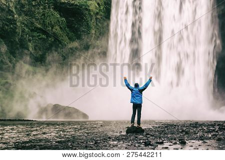Single Man Standing Near Scogafoss Waterfall In Iceland And Spread His Hands. Travel Summer Nordic C
