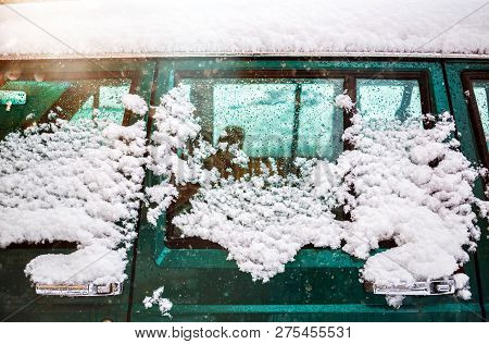 Snow-covered Windows Of A Classic Off-road Car. Wet Snow. End Of Winter