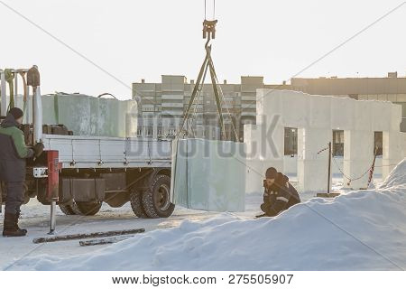 Worker In A Black Hat On Unloading
