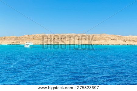White Yacht On A Sunny Day On The Red Sea Surrounded By Clear Blue Water
