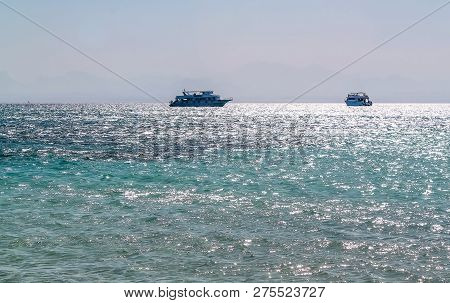 White Yacht On A Sunny Day On The Red Sea Surrounded By Clear Blue Water