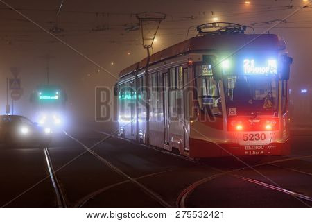 ST. PETERSBURG, RUSSIA - OCTOBER 11, 2018: Modern tram on operation in a misty evening. The city tramway system was the world longest since late 1980s till 2000s, but now has 4th place in the world