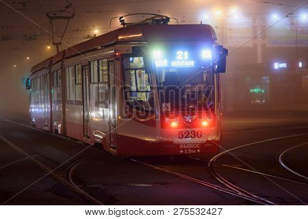 ST. PETERSBURG, RUSSIA - OCTOBER 11, 2018: Modern tram on operation in a misty evening. The city tramway system was the world longest since late 1980s till 2000s, but now has 4th place in the world