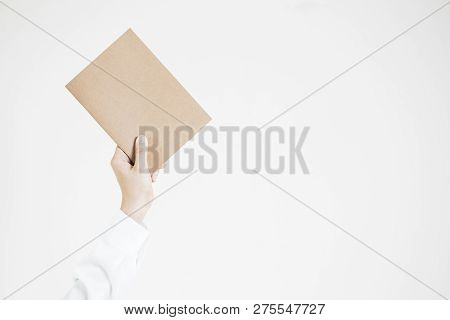 Business Women In The White Shirt Holding An Empty Brown Paper Up On The White Background.  Copy Spa