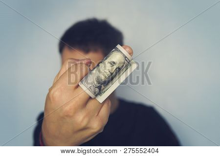 Guy Shows The Middle Finger On Which Are Wound 100 Dollar Banknote Of American Dollars. Major Shows 