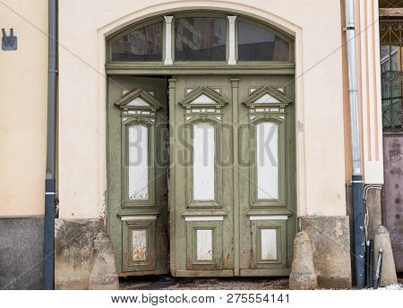 Opened , Green Hand Carved Wooden Entrance On A Residentual House .