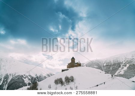 Stepantsminda, Gergeti, Georgia. Famous Ancient Gergeti Trinity Tsminda Sameba Church In Beautiful G