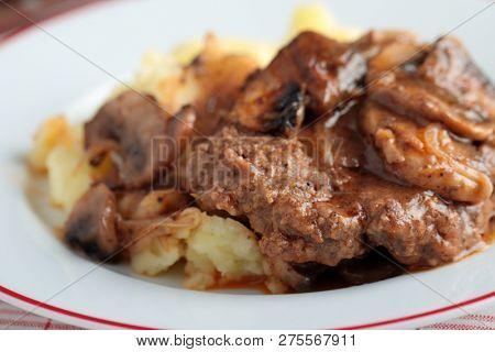 Salisbury steak with mashed potato under mushroom gravy