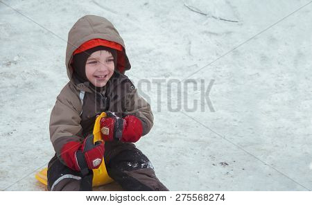 Sincere Children's Emotions. Сhild Ride Down A Snow Hill In Winter. Winter Fun Sliding Down (concept