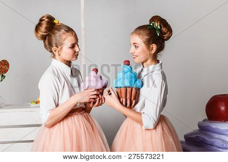 Beautiful Teenage Girls In Pink Tutu Skirts With Lollipops And Macaroons And Fansy Cakes In Studio O