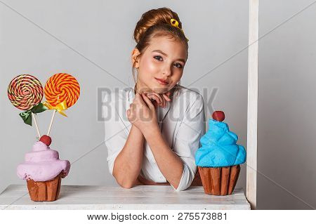 Beautiful Teenage Girls In Pink Tutu Skirts With Lollipops And Macaroons And Fansy Cakes In Studio O