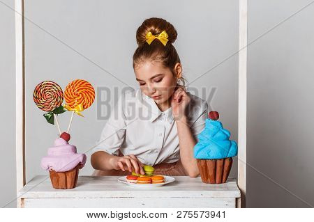 Beautiful Teenage Girls In Pink Tutu Skirts With Lollipops And Macaroons And Fansy Cakes In Studio O