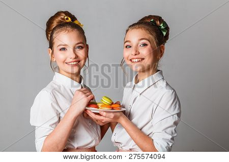 Beautiful Teenage Girls In Pink Tutu Skirts With Lollipops And Macaroons And Fansy Cakes In Studio O