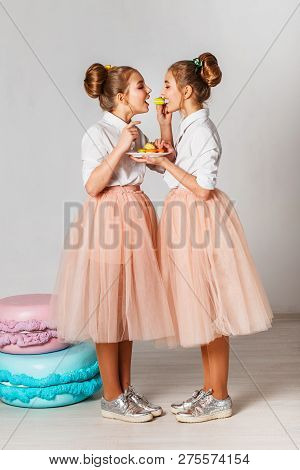 Beautiful Teenage Girls In Pink Tutu Skirts With Lollipops And Macaroons And Fansy Cakes In Studio O