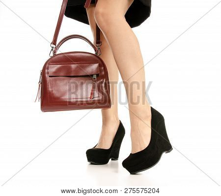 Woman Legs Feet Black Dress Shoes Red Purse Bag On White Baclground Isolation