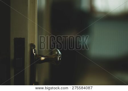 An Opening Door To A Darker Room