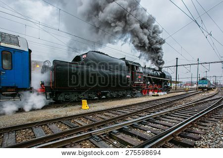 Prague, Czech Republic / Europe - December 15 2018: Old Black Steam Engine With Tender, Red Wheels, 