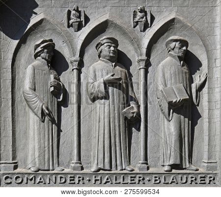 ZURICH, SWITZERLAND - JUNE 23, 2018: Fathers of the Reformed Churches of Switzerland: Comander, Haller, Blaurer, relief on the door of the Grossmunster (