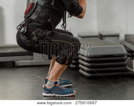 Closeup Of Woman In Ems Suit Doing Squat Exercise