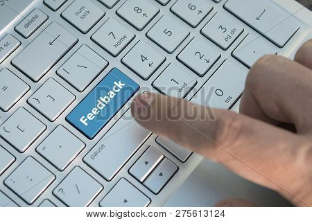 Computer Key Showing The Word Feedback. Message On Keyboard Key, A Male Finger Presses A Color Butto