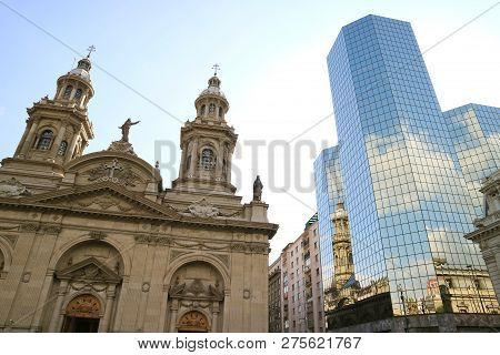 Metropolitan Cathedral Of Santiago Reflected In The Glass Clad Facade Of The Modern Building, Plaza 