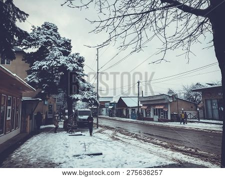 Bakuriani, Georgia - November 17, 2018: Winter Noon. People Walk In The Snow. Snowy Street. Mountain