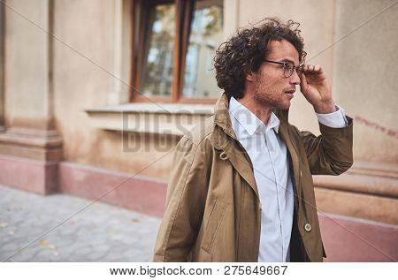 Horizontal Side View Potrait Of Young Businessman With Glasses Posing Outdoors. College Male Student