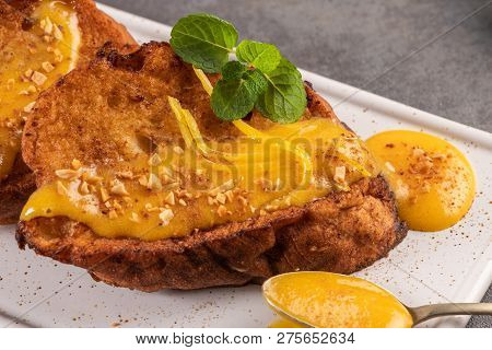 Traditional Christmas Rabanadas with egg yolk cream and cinnamon. Spanish Torrijas close up on the countertop.
