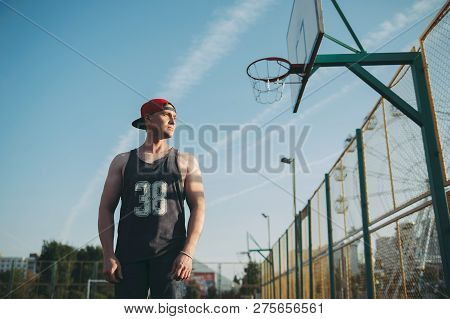Guy In A Red Baseball Cap On The Basketball Court